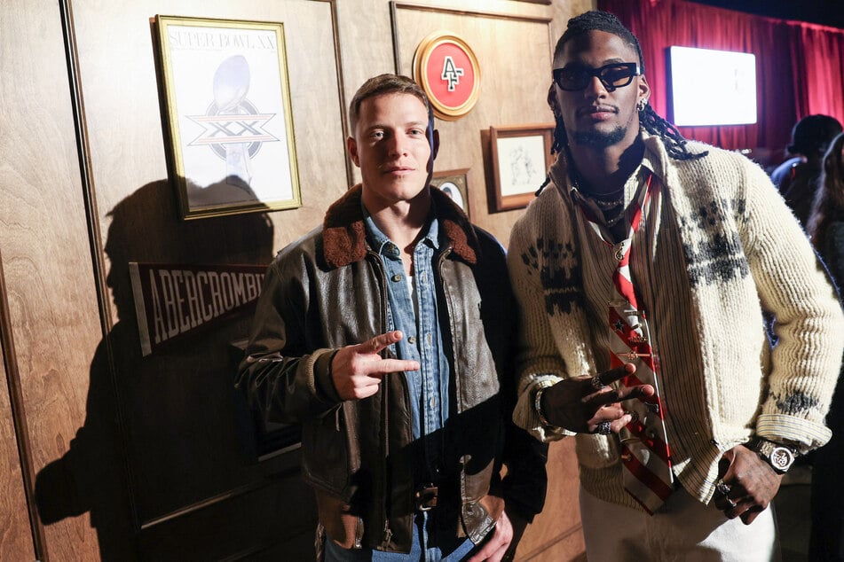 San Francisco 49ers running back Christian McCaffrey (l.) and Dallas Cowboys wide receiver CeeDee Lamb attend the Abercrombie and Fitch NFL Super Bowl weekend fashion presentation at the NFL Culture Club at The Pearl in San Francisco, California, on February 7, 2026.