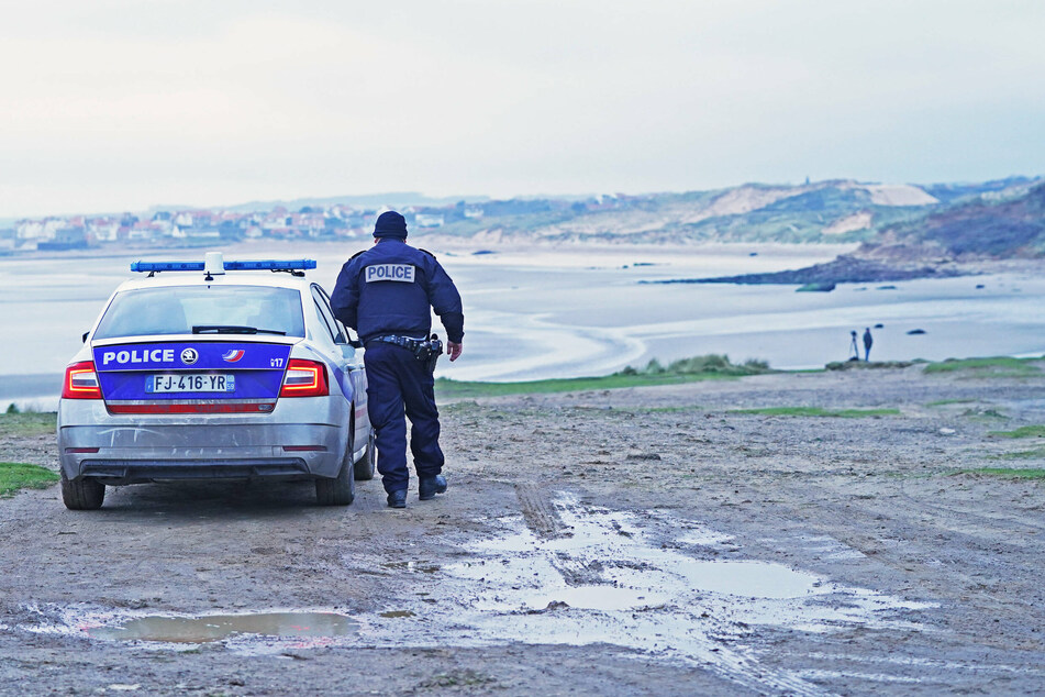 French police look out over the coast at Wimereux, in northern France, at a stretch of beach believed to be used by migrants and refugees to cross the English Channel.