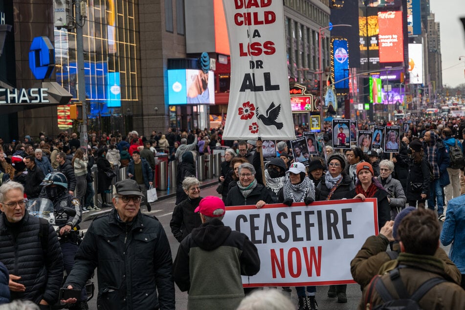 Over one thousand people participate in a silent march and protest in midtown Manhattan against the deaths of Palestinians in Gaza on December 28, 2023 in New York City. The action, which was organized partly by elderly Jewish groups, included the carrying of hundreds of small effigies representing some of the thou
