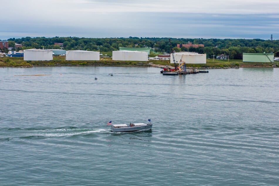 A ferry sails by petroleum tanks in Portland, Maine.