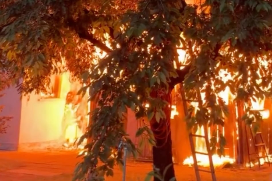 Die Flammen griffen auch auf das Dach eines benachbarten Gebäudes über.