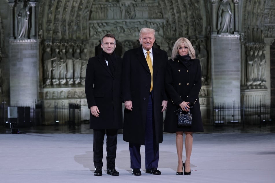 French President Emmanuel Macron (L) and his wife Brigitte Macron (R) pose with US President-elect Donald Trump (C) outside Notre Dame Cathedral ahead of a ceremony to mark the re-opening of the landmark cathedral, in central, Paris on Saturday.