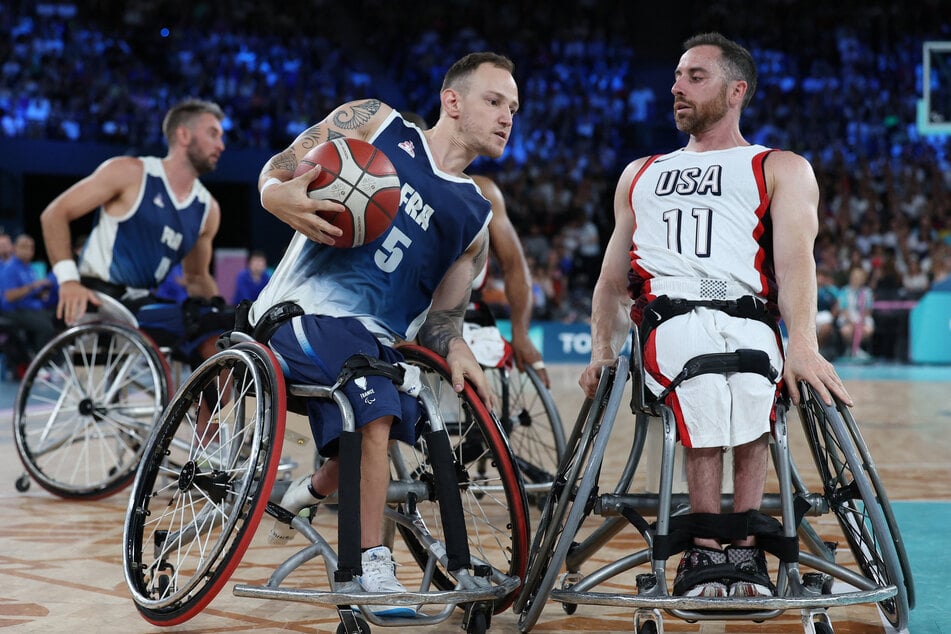 Steve Serio of Team USA in action against Alexis Ramonet of France during the wheelchair basketball men's quarter-final at the Paris Paralympics.