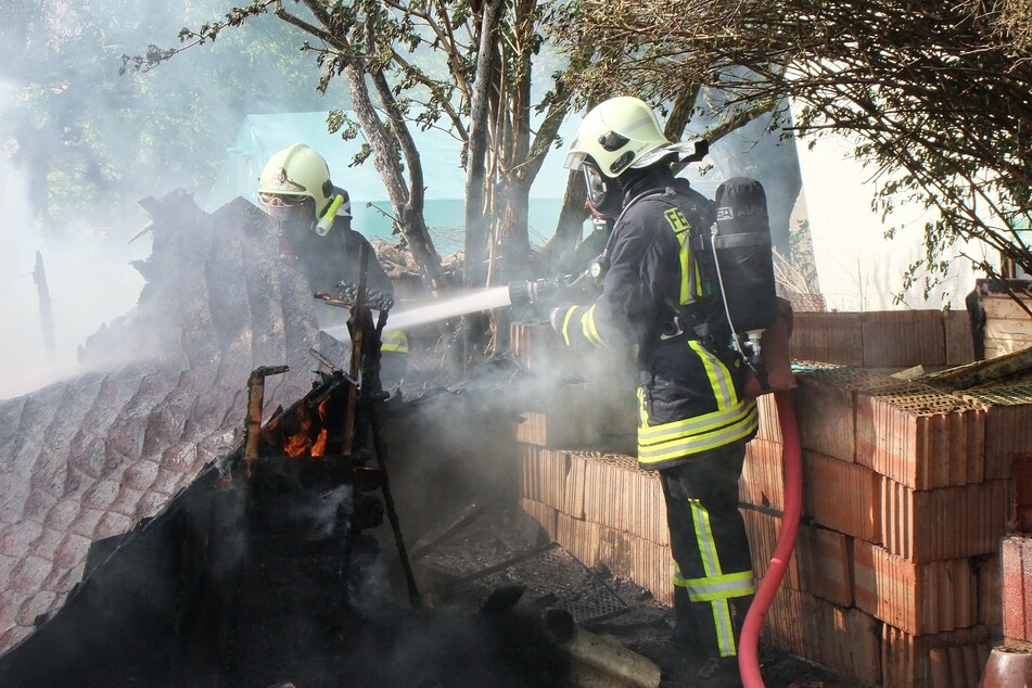 Die Feuerwehr löschte die brennenden Gartenlauben.