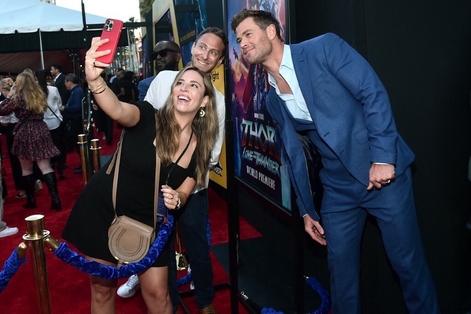 Chris Hemsworth taking pictures with fans at the premiere of Thor: Love and Thunder.