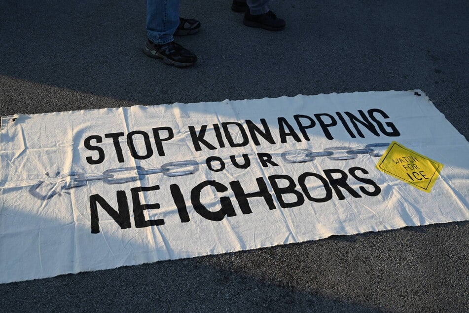 A banner reads "Stop Kidnapping Our Neighbors" as protesters gather outside the Broadview ICE facility in Illinois.