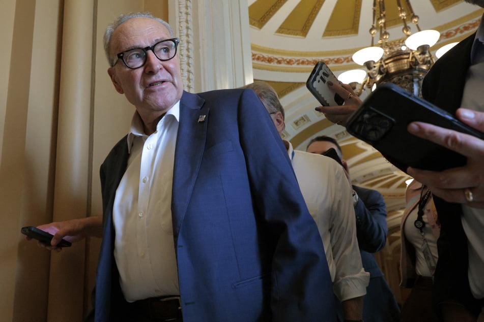 Senate Minority Leader Charles Schumer (D-NY) is pursued by reporters as he arrives at the US Capitol on Monday in Washington, DC.