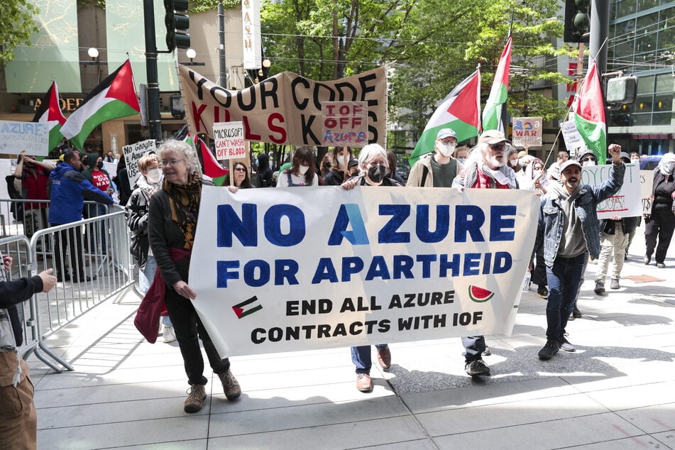 Pro-Palestinian demonstrators hold banners and signs as they rally outside the Microsoft Build conference at the Seattle Convention Center in Washington on May 19, 2025.