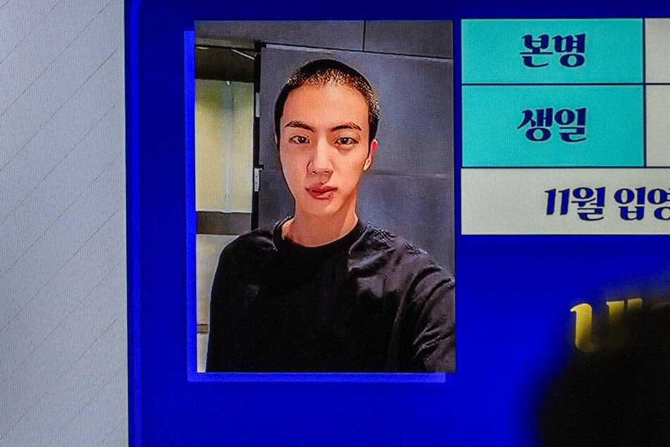 A still from a South Korean network news report on Jin of BTS beginning his military service.