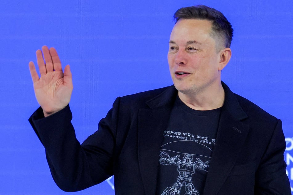 Elon Musk waves to the crowd during the 56th annual World Economic Forum meeting in Davos, Switzerland, on January 22, 2026.