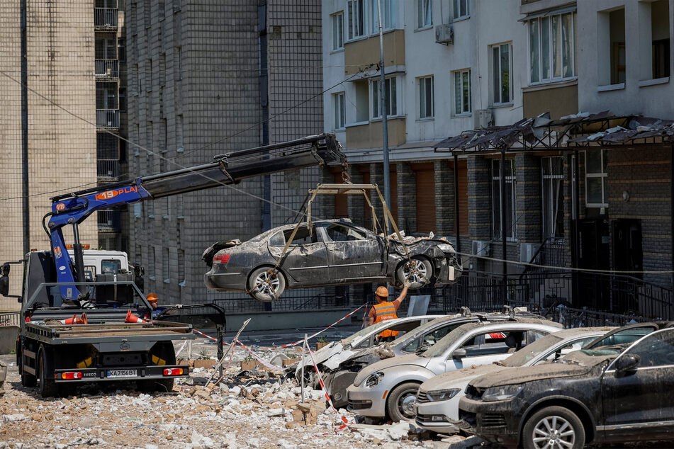 Destroyed cars were removed after heavy damage during a Russian drone strike in Kyiv, Ukraine.