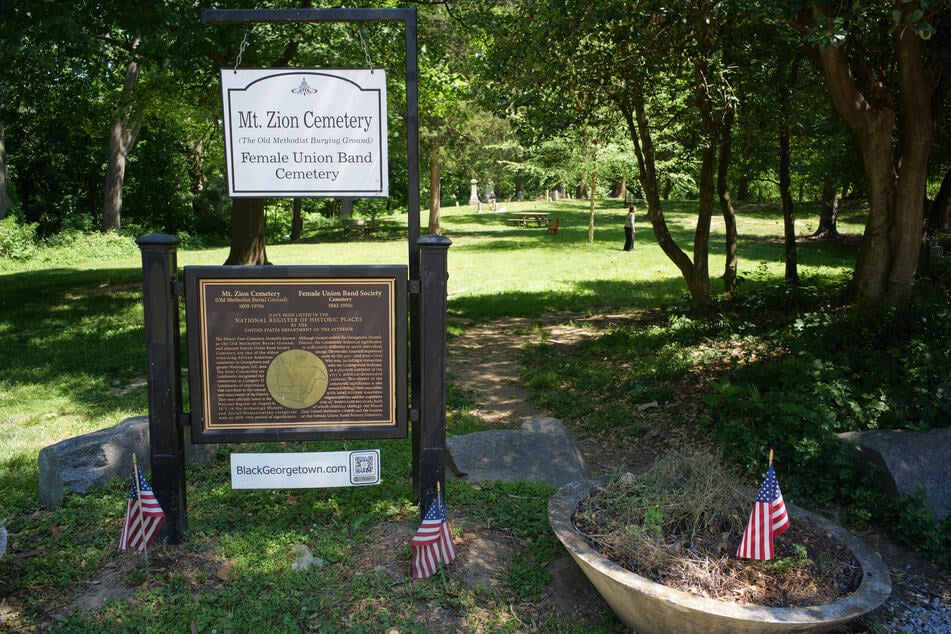 Signs outside of the Mount Zion Cemetery/Female Union Band Society Cemetery are seen in the Georgetown neighborhood of Washington DC on May 10, 2026.