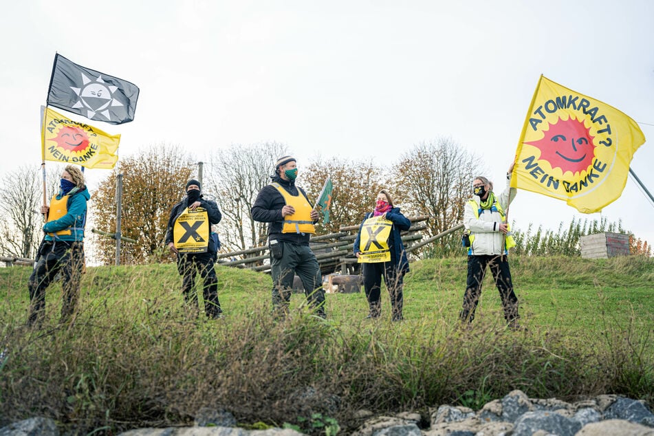 Aktivisten stehen mit Fahnen in der Nähe des Union-Piers in Nordenham.
