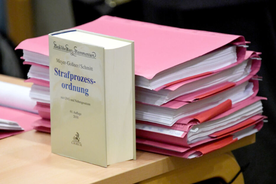 Gerichtsakten liegen auf einem Tisch im Verhandlungssaal. (Symbolbild)