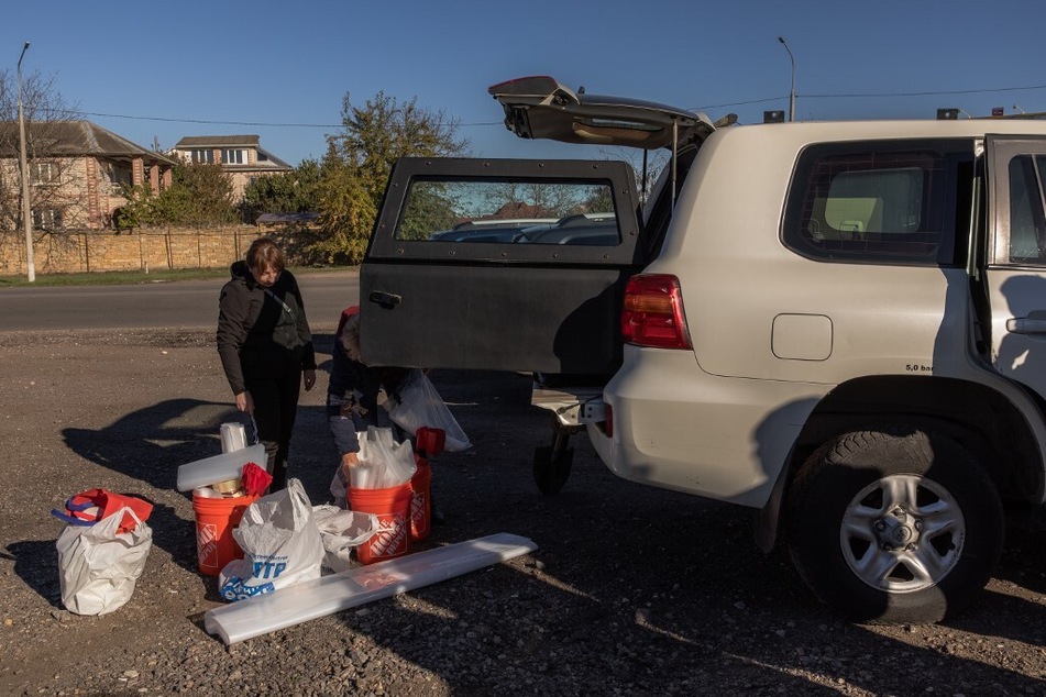 Ecological investigators prepare equipment to collect soil in the area that was flooded following the Kakhovka dam explosion.