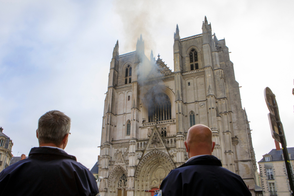 Polizisten stehen vor der brennenden Kathedrale im französischen Nantes.