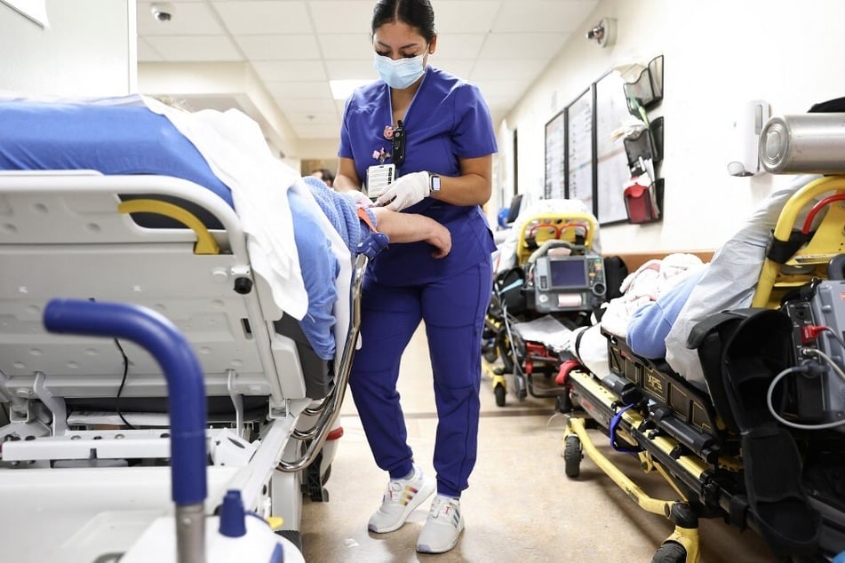 A lab technician cares for a patient in the Emergency Department at Providence St. Mary Medical Center in Apple Valley, California.