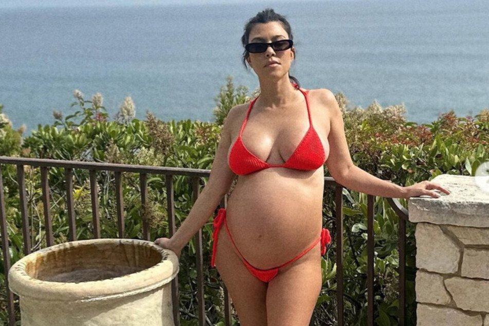Kourtney Kardashian bared her bump in red bikini in a new Instagram post.