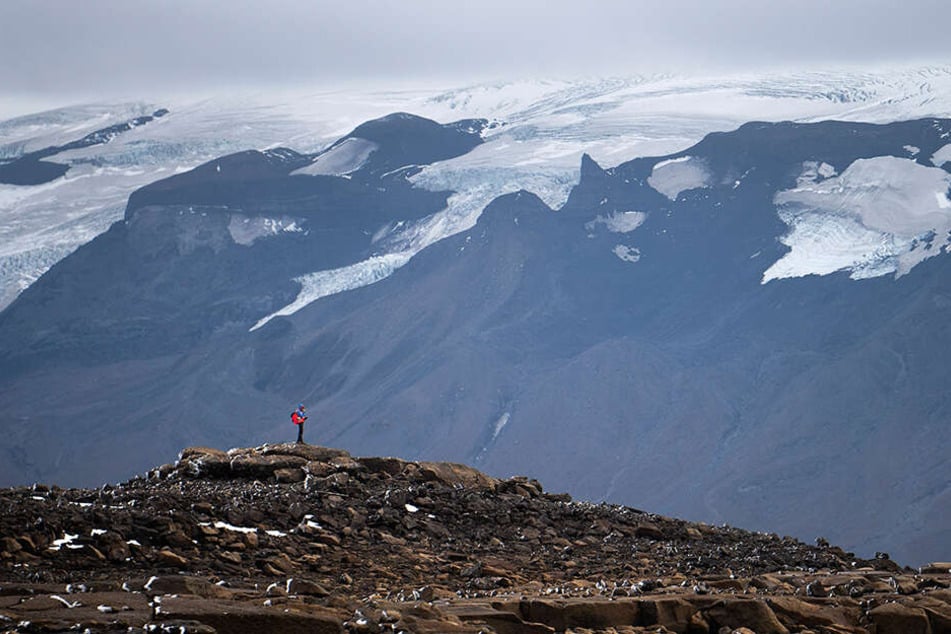 Ein Mann wandert über das Geröll am Okjökull zu einer Gedenkveranstaltung für den vergangenen Gletscher.