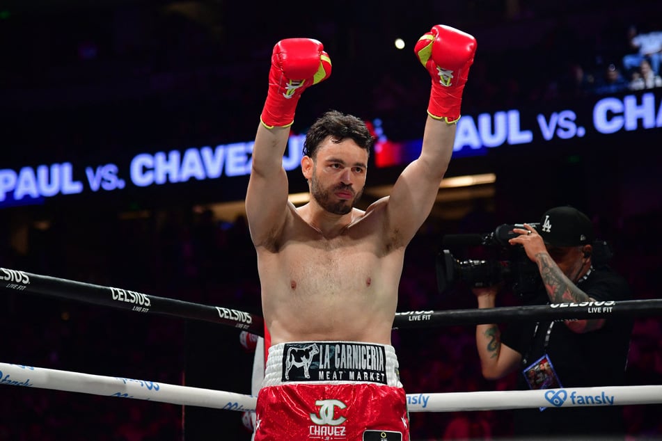 Mexican boxer Julio Cesar Chavez Jr. raises his fists before fighting against Jake Paul at Honda Center in Anaheim, California, on June 28, 2025.