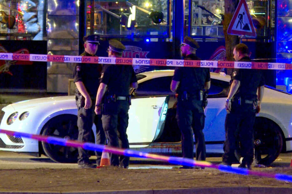 Polizisten stehen neben einem Auto auf dem Millerntorplatz an der Reeperbahn, nachdem Schüsse gefallen waren.