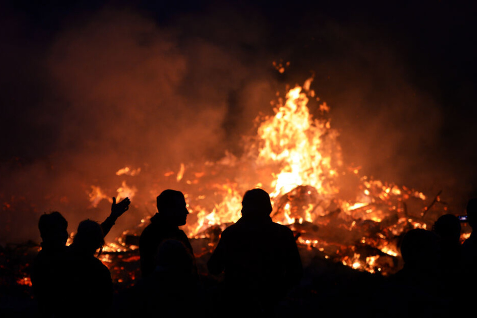 Menschen stehen an einem Osterfeuer in Seeburg (Brandenburg) bei Berlin. (2014)