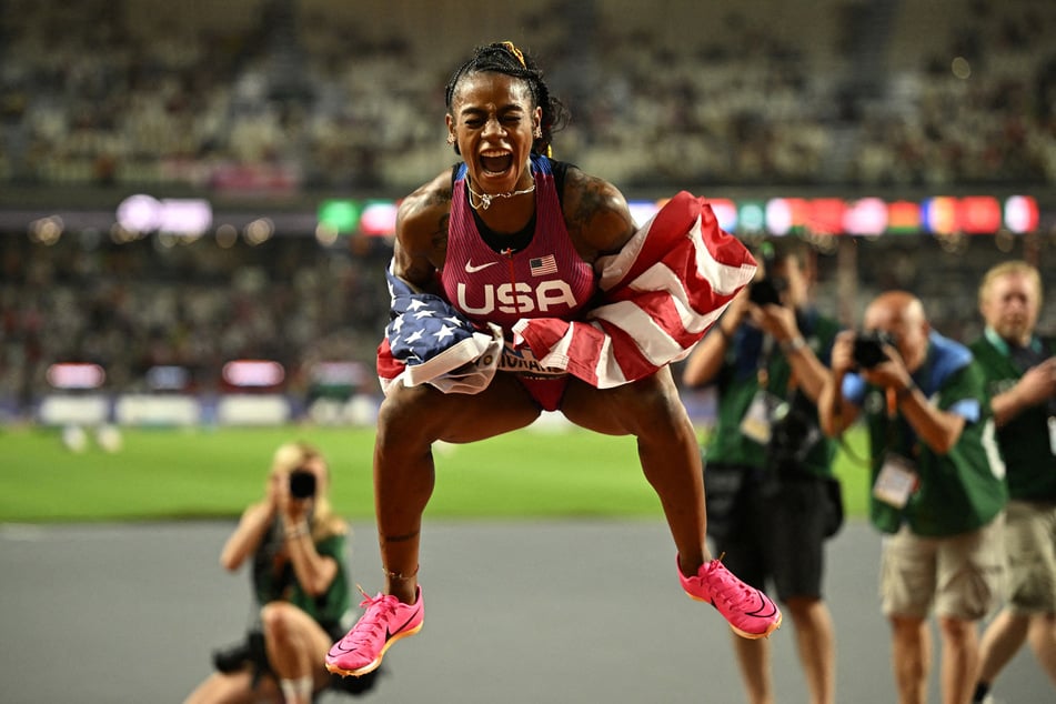 Sha'Carri Richardson jumps into the air after becoming a world champion.