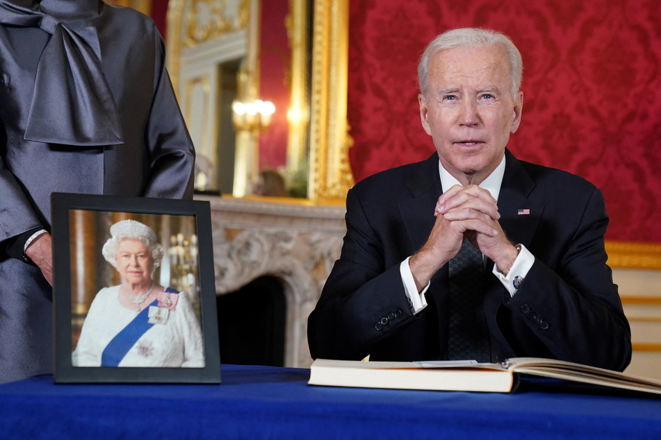 US President Joe Biden signs a condolence book for the UK's Queen Elizabeth II at Lancaster House in London.