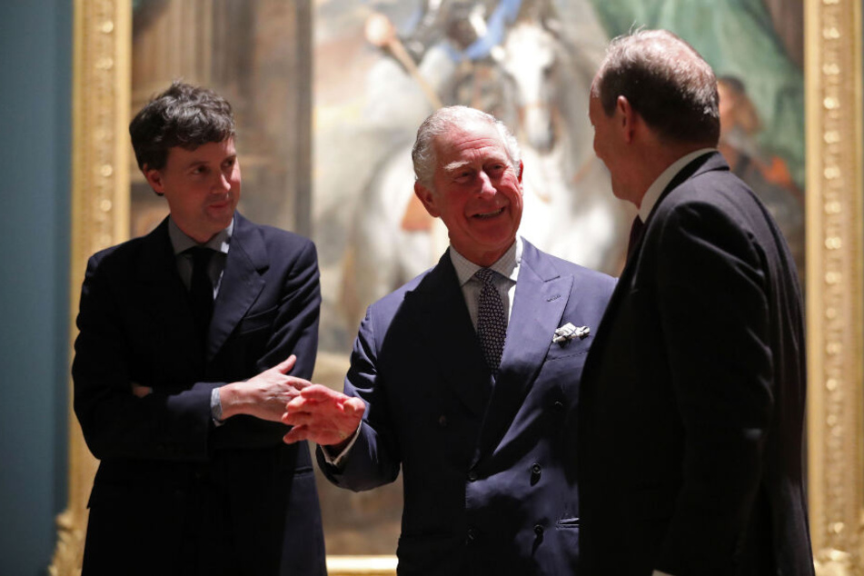 Prinz Charles bei einem Besuch der Ausstellung "Charles I: King and Collector" in der Royal Academy of Arts. Neben ihm stehen die Kuratoren Desmond Shawe-Taylor (r.) und Per Rumberg.
