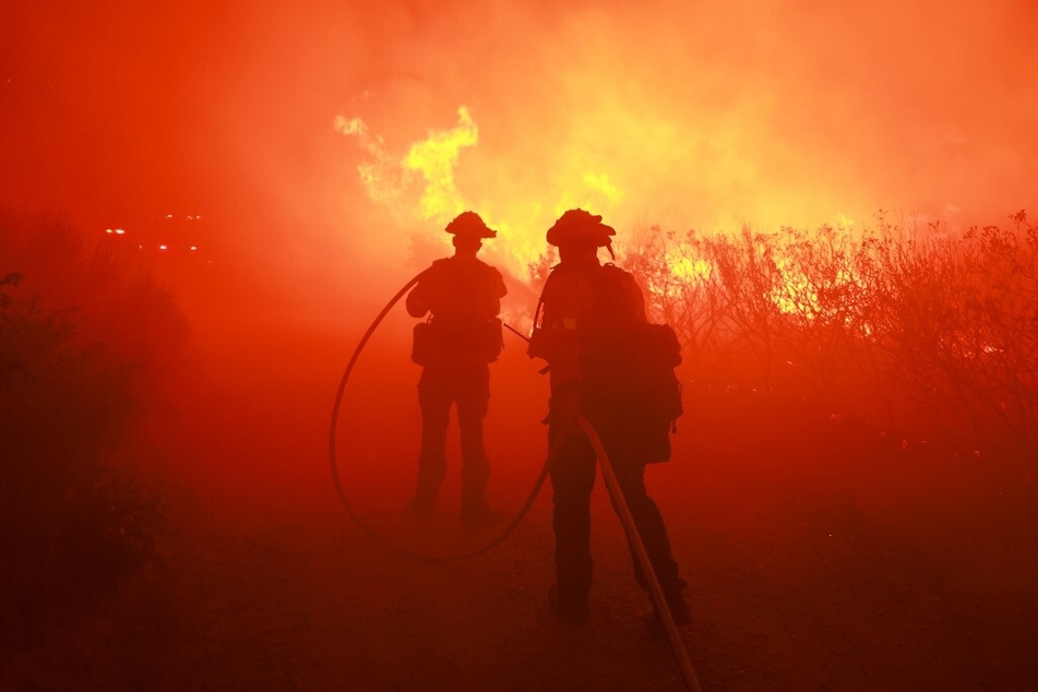 Firefighters respond to the Post Fire as it burns through the Hungry Valley State Vehicular Recreation Area in Lebec, California.