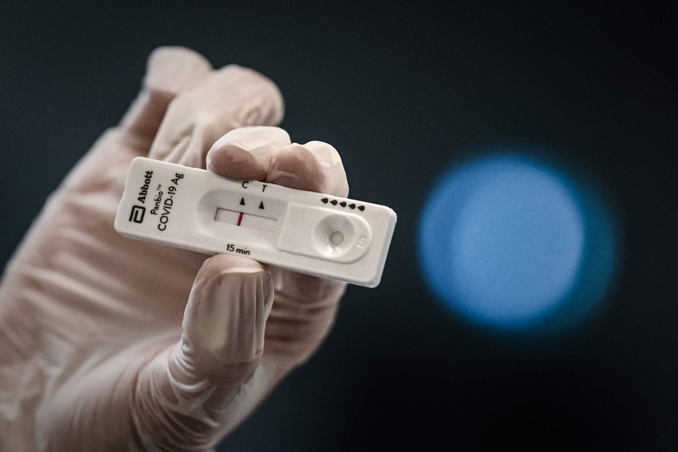 Medizinisches Personal hält in der Notaufnahme des Krankenhauses Saint-Andre einen Corona-Schnelltest in der Hand.