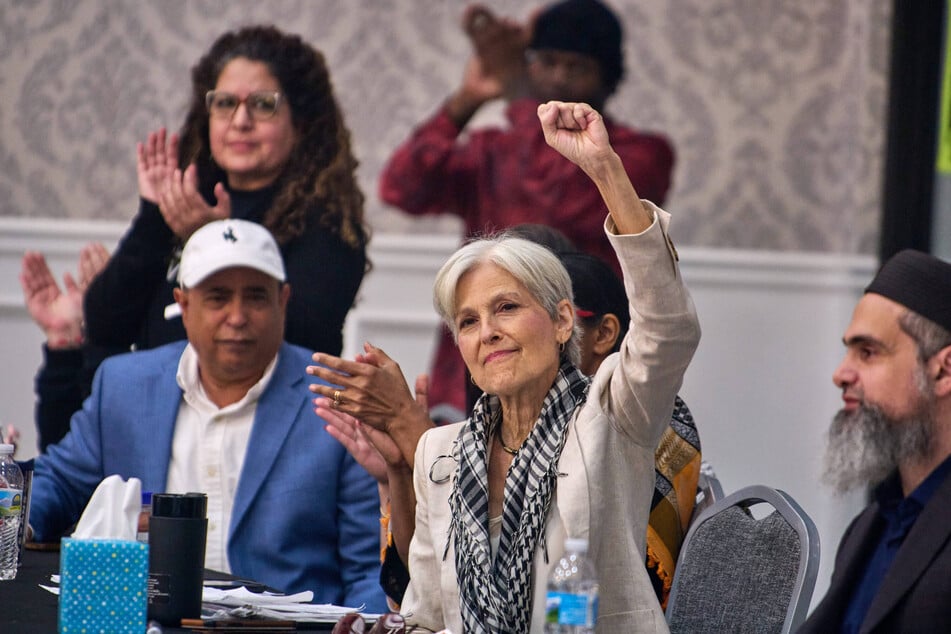 Green Party presidential nominee Dr. Jill Stein raises her fist during an event with Workers Strike Back and the Abandon Harris Campaign at the Bint Jebail Cultural Center in Dearborn, Michigan.