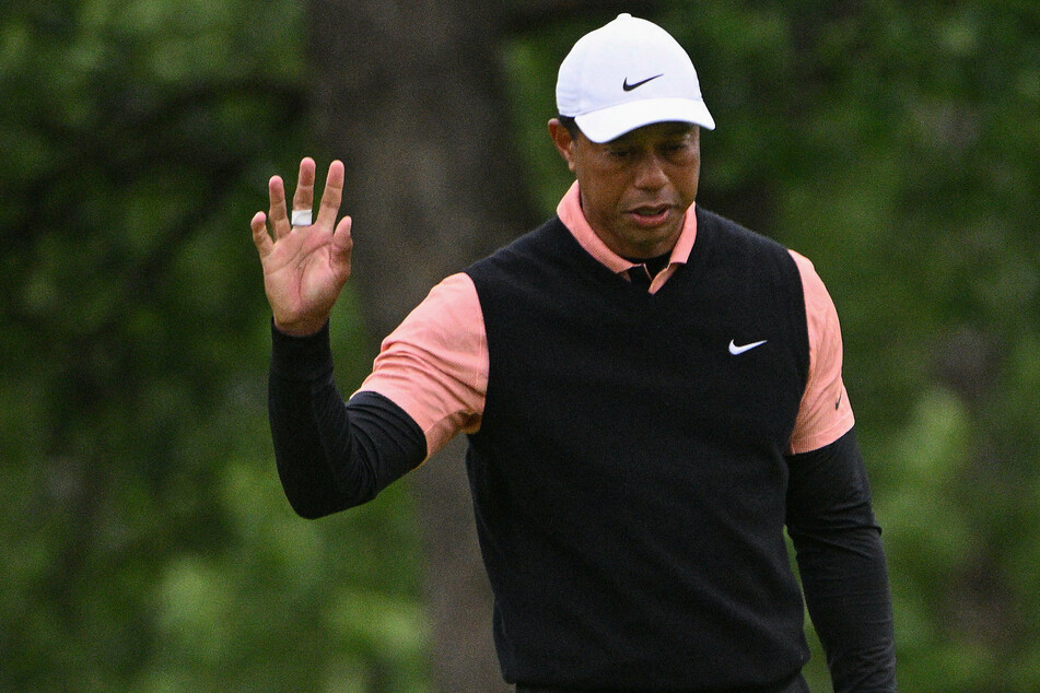Tiger Woods raises a tired hand to acknowledge the crowd during the third round of the PGA Championship.