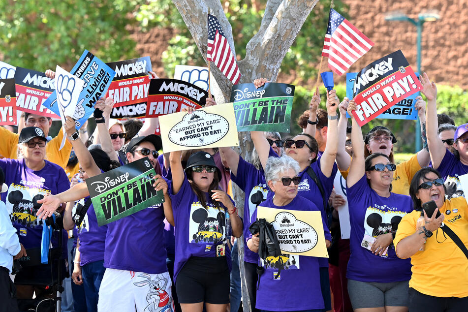 Disney employees rally outside the main entrance of Disneyland Resort in Anaheim, California, on July 17, 2024, ahead of a planned strike authorization vote.