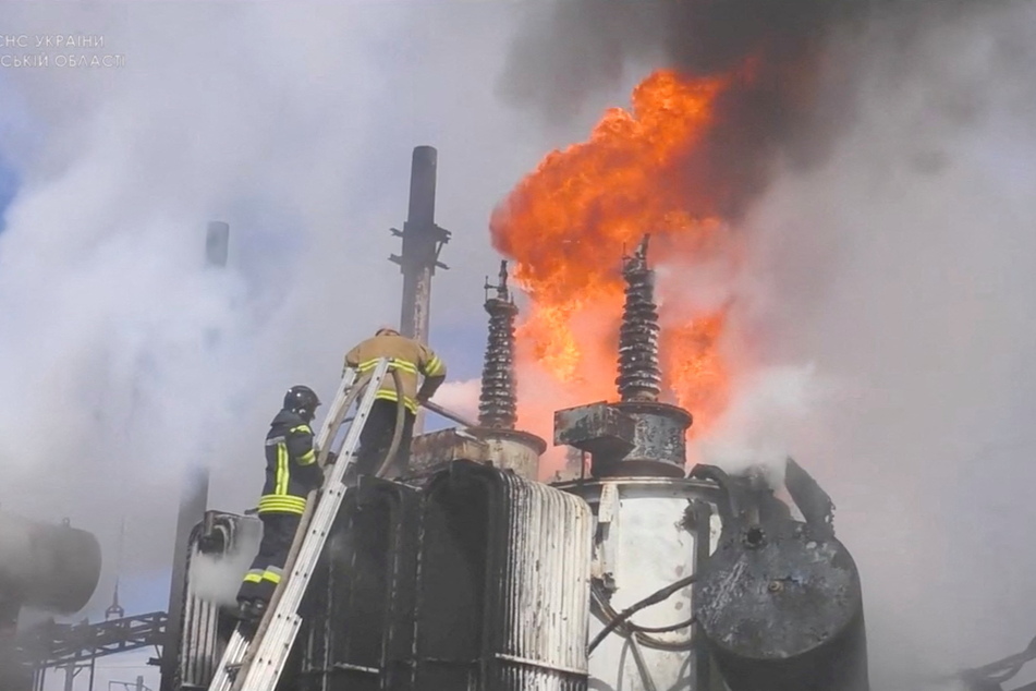 Firefighters battle the flames at a substation near the Krasne Railway Station in the aftermath of a Russian attack.