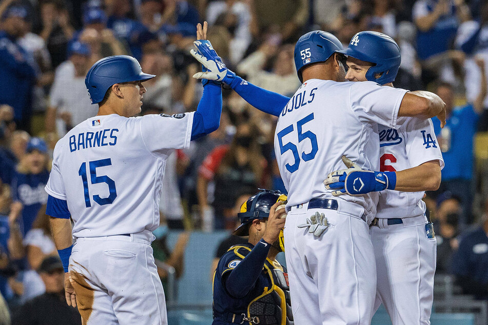 Austin Barnes and Albert Pujols congratulate Turner on his fifth-inning grand slam.