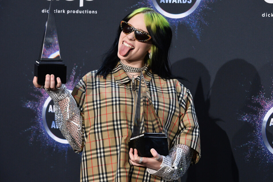 Billie Eilish (18) holding her awards for New Artist of the Year and Alternative Artist during the 47th annual American Music Awards.