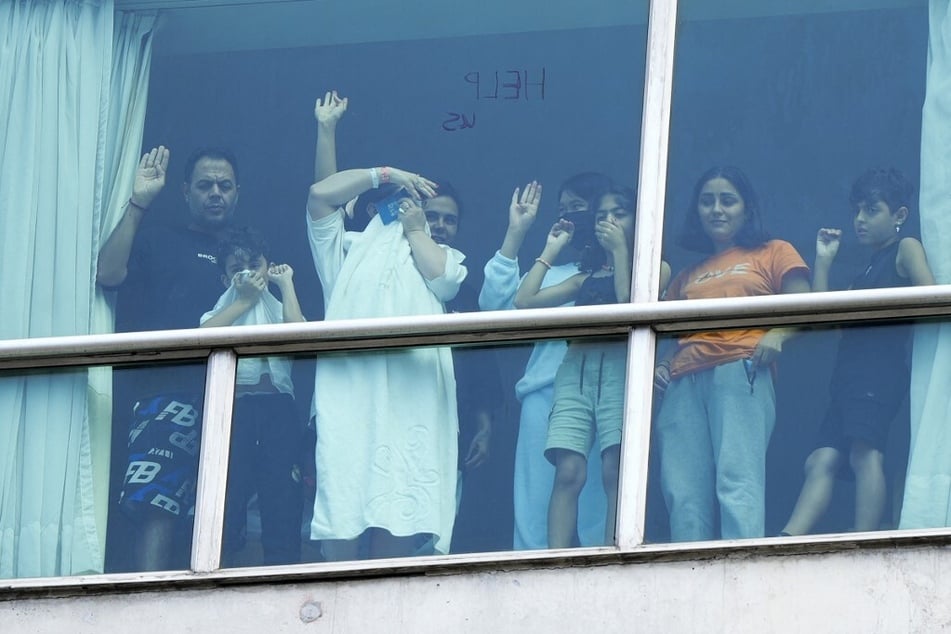 Migrants deported from the US look out the window of the Decapolis Hotel in Panama City on February 18, 2024.