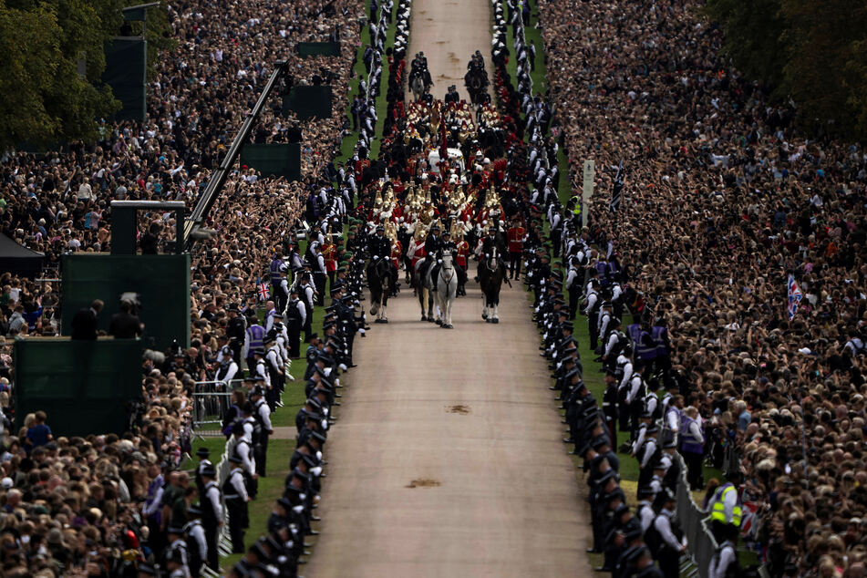 Thousands line the route of the funeral procession as it makes its way to Windsor Castle.