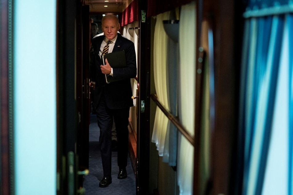 President Joe Biden walks down a train corridor to his cabin after a surprise visit with Ukrainian President Volodymyr Zelensky in Kyiv on February 20, 2023.