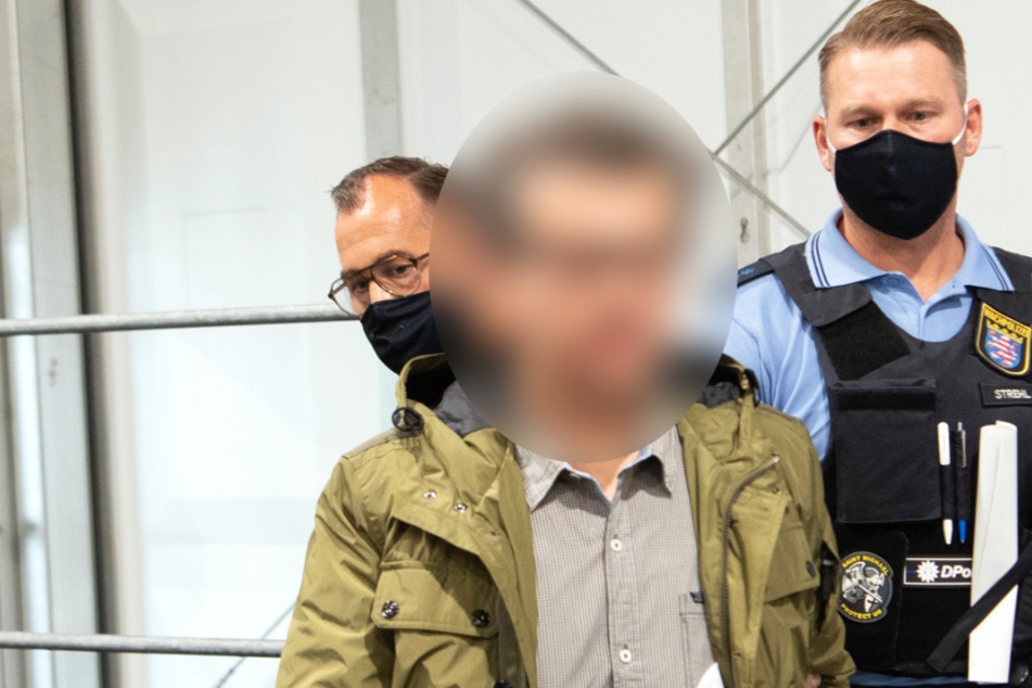 Der Angeklagte wird in den Gerichtssaal geführt.