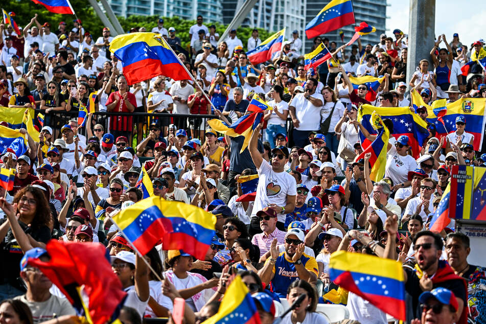 People wave flags during the "Protest for Truth" demonstration called by the Venezuelan opposition to demand that the Venezuelan government recognize Edmundo Gonzalez Urrutia's victory in the presidential elections in Miami, Florida, on August 17.