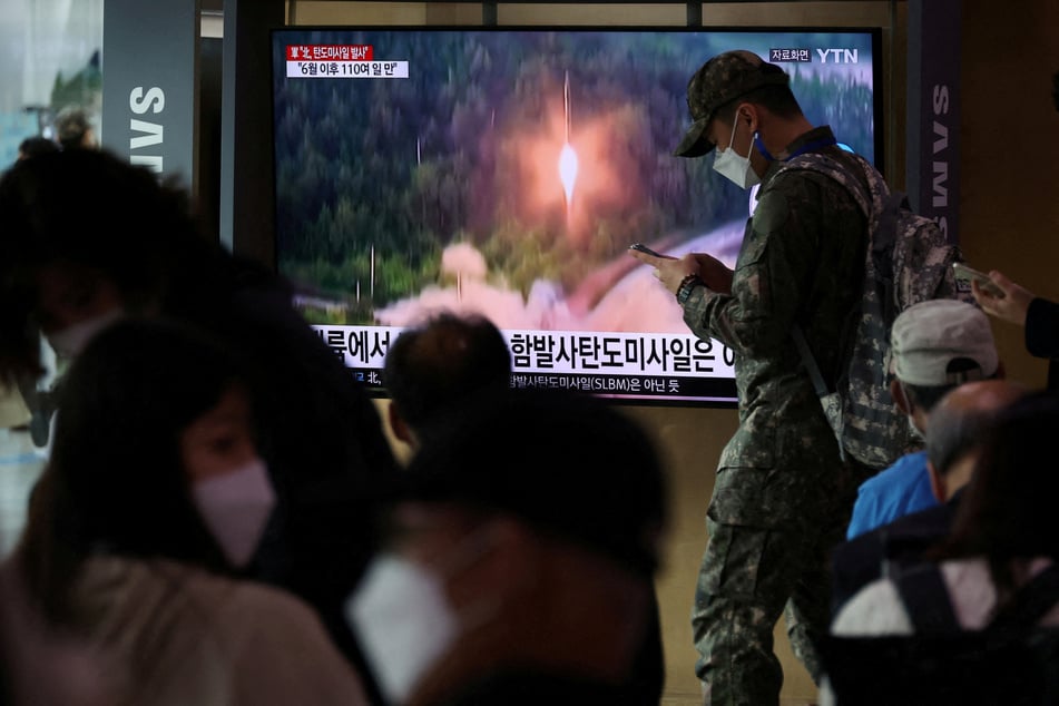 A South Korean soldiers walks past a TV broadcasting a news report on North Korea firing a ballistic missile towards the sea off its east coast in September.