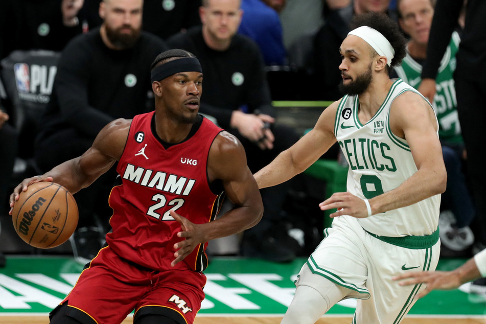 Miami Heat forward Jimmy Butler dribbles against Boston Celtics guard Derrick White during the second half in Game 1 of the 2023 Eastern Conference Finals at TD Garden.