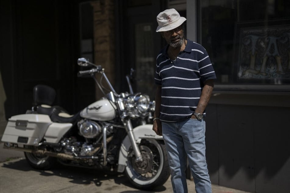 Dennis Frison stands next to a Harley Davidson in downtown Scranton, Pennsylvania.