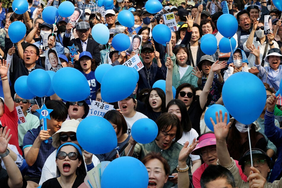 Supporters of Lee Jae-myung, the presidential candidate for South Korea's Democratic Party, cheer during an election campaign rally at a park in Seoul.