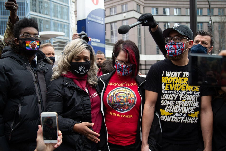 Toshira Garraway (2nd from l.), founder of Families Supporting Families Against Police Violence , and Courtney Ross (3rd from l.), Floyd's girlfriend surrounded by media as jury reaches verdict in Floyd death.