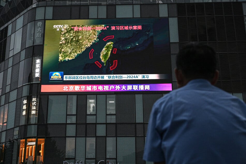 An outdoor screen shows a news coverage of China’s military drills around Taiwan, in Beijing on May 23.