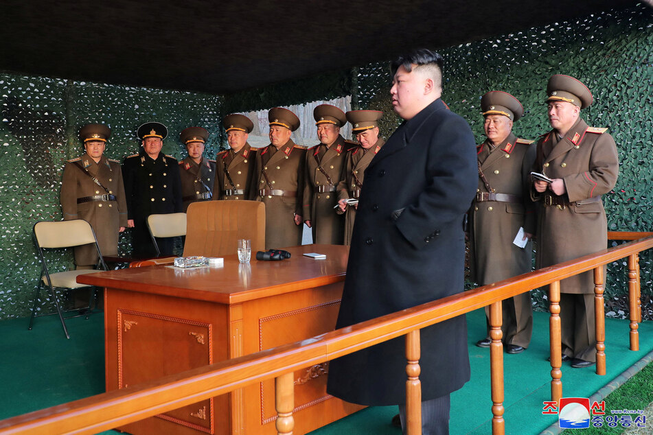 North Korean leader Kim Jong Un watches a fire assault drill at an undisclosed location in North Korea on March 10, 2023.