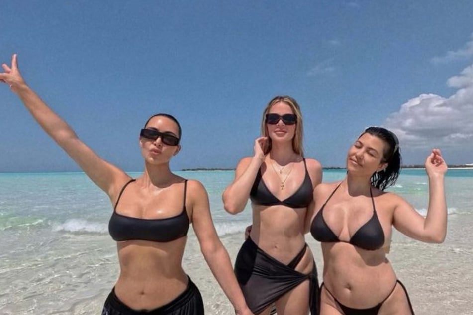 Kourtney Kardashian (r.) has defended her post-partum body in a poignant response to a critic of her appearance.